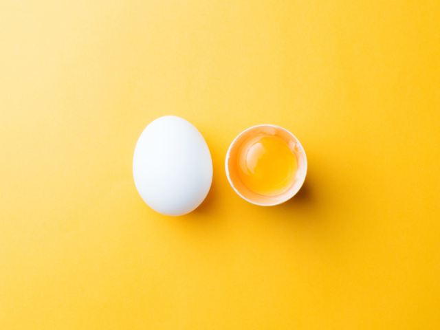 Two eggs on a yellow background.
